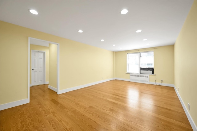 65-05 Yellowstone Blvd Unit 1A, Forest Hills, NY 11375 - empty room featuring light wood finished floors, radiator heating unit, recessed lighting, and cooling unit