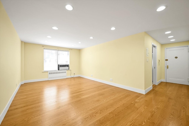 65-05 Yellowstone Blvd Unit 1A, Forest Hills, NY 11375 - empty room with light wood-style flooring, recessed lighting, and radiator heating unit