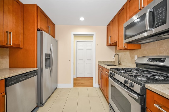 65-05 Yellowstone Blvd Unit 1A, Forest Hills, NY 11375 - kitchen with stainless steel appliances, tasteful backsplash, brown cabinets, light tile patterned floors, and recessed lighting