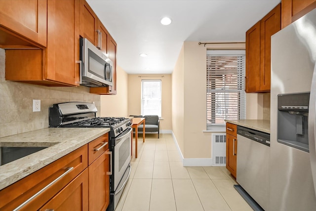 65-05 Yellowstone Blvd Unit 1A, Forest Hills, NY 11375 - kitchen with appliances with stainless steel finishes, backsplash, brown cabinetry, and recessed lighting
