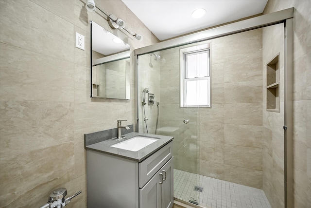 65-05 Yellowstone Blvd Unit 1A, Forest Hills, NY 11375 - bathroom with vanity, a stall shower, and tile walls