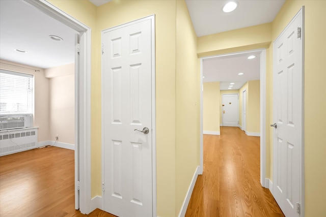 65-05 Yellowstone Blvd Unit 1A, Forest Hills, NY 11375 - hallway featuring light wood-style flooring, radiator, cooling unit, and recessed lighting