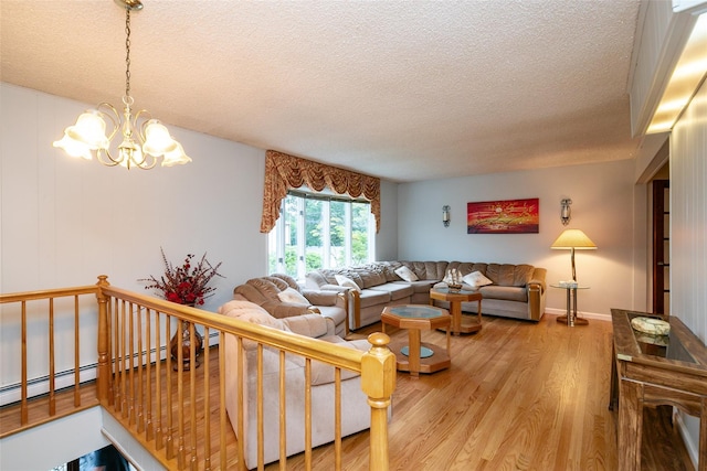 24 Hickory St, Deer Park, NY 11729 - living area with a textured ceiling, light wood-type flooring, and a chandelier