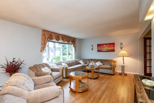 24 Hickory St, Deer Park, NY 11729 - living room with a textured ceiling and light wood-style floors