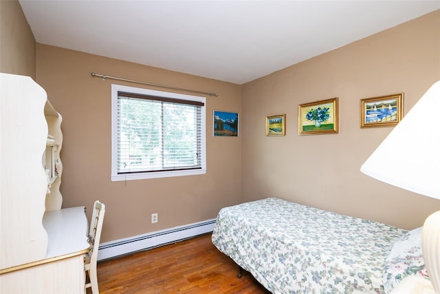 24 Hickory St, Deer Park, NY 11729 - bedroom with a baseboard heating unit and wood finished floors