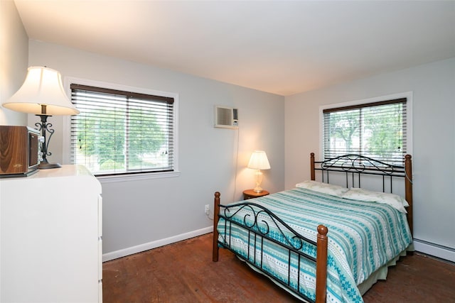 24 Hickory St, Deer Park, NY 11729 - bedroom featuring multiple windows, a baseboard heating unit, wood finished floors, and a wall unit AC