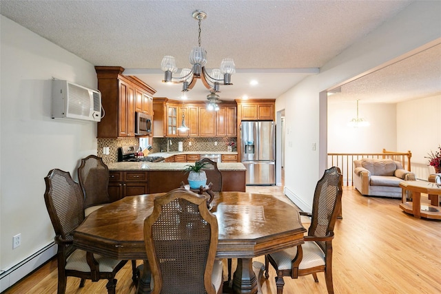 24 Hickory St, Deer Park, NY 11729 - dining room featuring a chandelier, a baseboard radiator, light wood-style flooring, a wall mounted air conditioner, and a textured ceiling