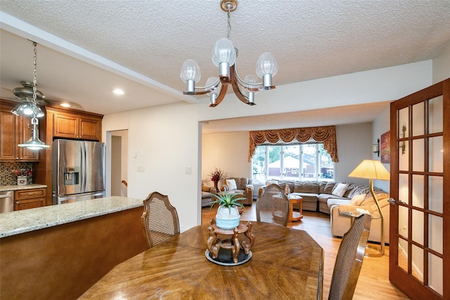 24 Hickory St, Deer Park, NY 11729 - dining room with light wood finished floors, a chandelier, recessed lighting, and a textured ceiling