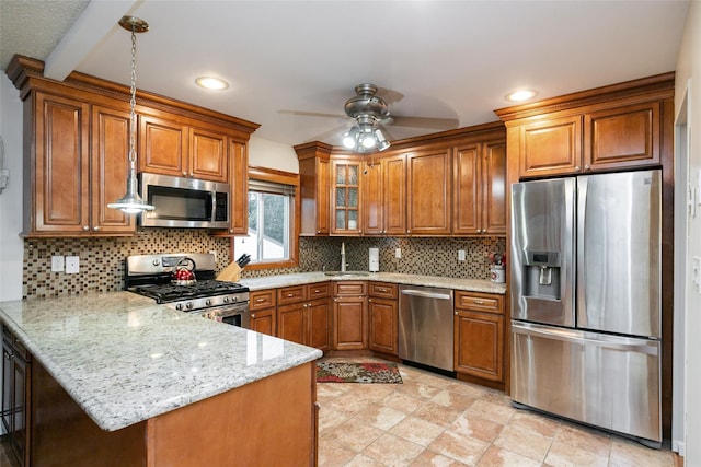 24 Hickory St, Deer Park, NY 11729 - kitchen with appliances with stainless steel finishes, brown cabinetry, a peninsula, a ceiling fan, and recessed lighting