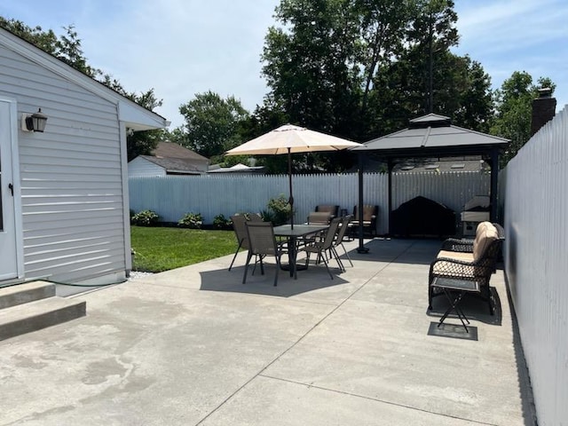 66 Eimer St, Patchogue, NY 11772 - fenced backyard featuring a gazebo, outdoor dining area, a patio, and entry steps