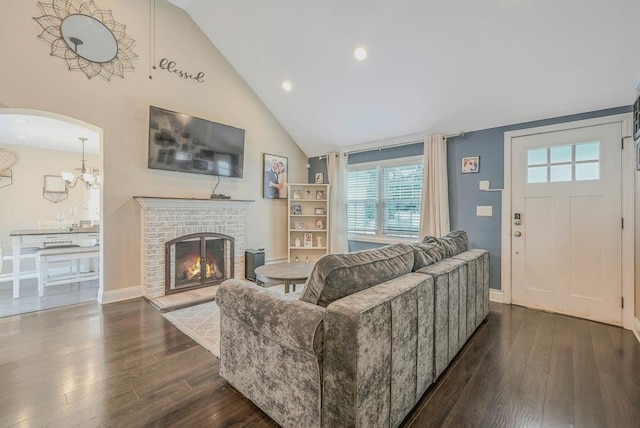 66 Eimer St, Patchogue, NY 11772 - living room with high vaulted ceiling, dark wood-type flooring, healthy amount of natural light, a fireplace, and a chandelier
