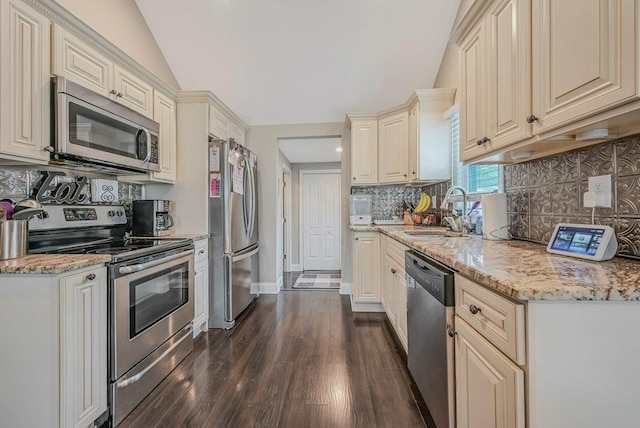 66 Eimer St, Patchogue, NY 11772 - kitchen featuring appliances with stainless steel finishes, lofted ceiling, dark wood-style floors, tasteful backsplash, and light stone countertops