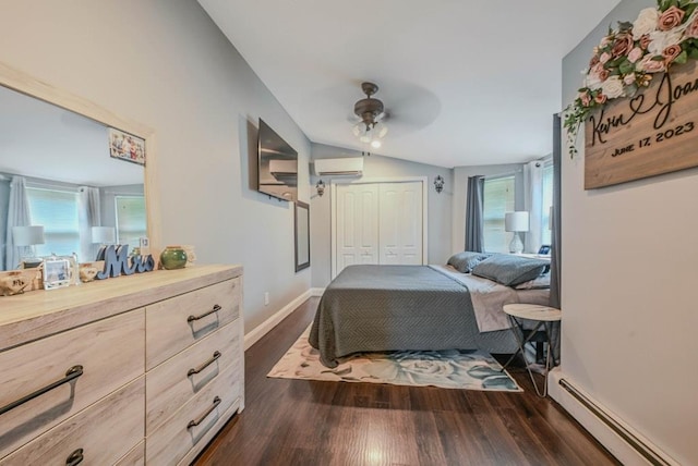 66 Eimer St, Patchogue, NY 11772 - bedroom featuring baseboard heating, a wall unit AC, dark wood-style floors, a closet, and vaulted ceiling