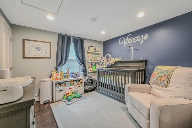 66 Eimer St, Patchogue, NY 11772 - bedroom with wood finished floors, recessed lighting, and a crib