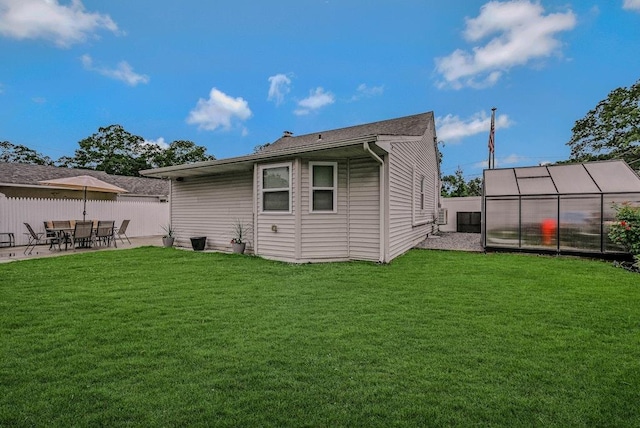 66 Eimer St, Patchogue, NY 11772 - back of property featuring an exterior structure, an outdoor structure, and a patio