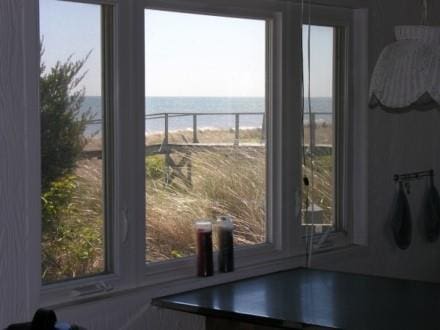 54 Lewis Walk, Cherry Grove, NY 11782 - doorway to outside featuring plenty of natural light and a water view