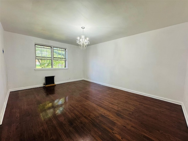 77-04 141st St Unit 67F, Flushing, NY 11367 - spare room with radiator, a chandelier, and dark wood finished floors