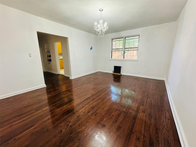 77-04 141st St Unit 67F, Flushing, NY 11367 - spare room with a chandelier, dark wood-style floors, and radiator heating unit