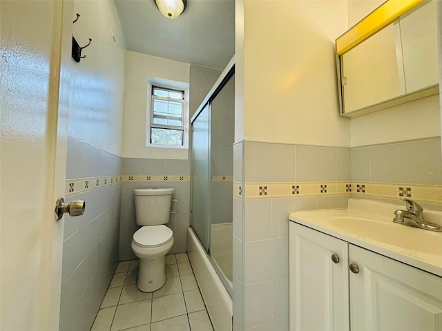 77-04 141st St Unit 67F, Flushing, NY 11367 - bathroom with tile walls, tile patterned floors, vanity, shower / bath combination with glass door, and wainscoting