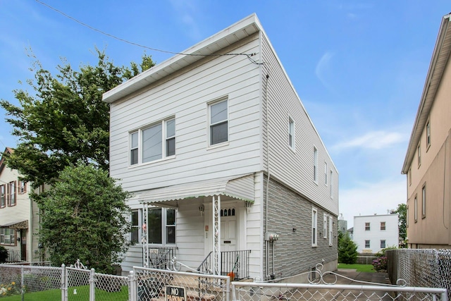 13-19 126th St, College Point, NY 11356 - view of front of house with a gate and a fenced front yard