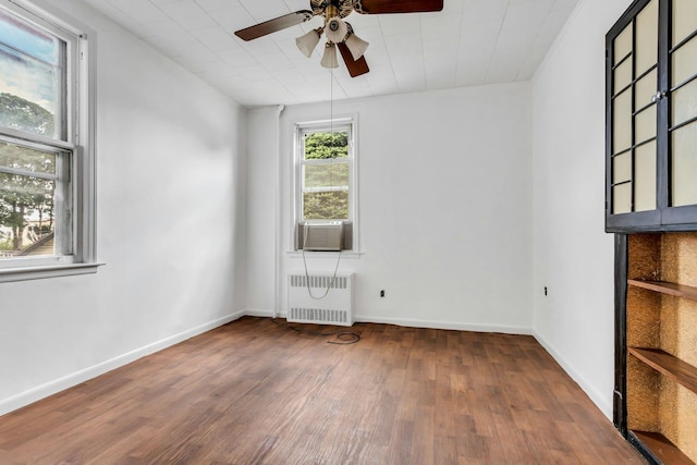 13-19 126th St, College Point, NY 11356 - unfurnished room featuring radiator heating unit, wood finished floors, ceiling fan, and cooling unit