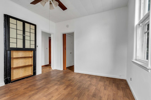 13-19 126th St, College Point, NY 11356 - empty room featuring a ceiling fan, wood finished floors, and healthy amount of natural light