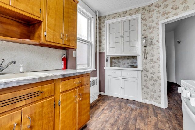 13-19 126th St, College Point, NY 11356 - kitchen with wallpapered walls, dark wood-style flooring, radiator heating unit, light countertops, and stove