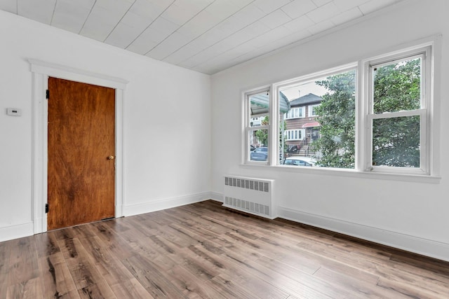 13-19 126th St, College Point, NY 11356 - empty room featuring radiator, wood finished floors, and crown molding