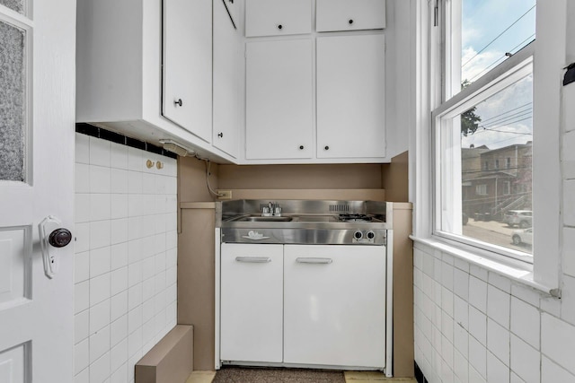 13-19 126th St, College Point, NY 11356 - kitchen with stainless steel counters, tile walls, and white cabinets