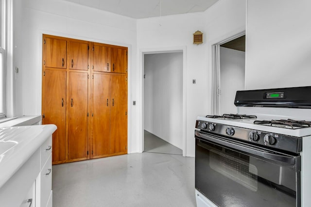 13-19 126th St, College Point, NY 11356 - kitchen featuring stove, brown cabinets, and light countertops
