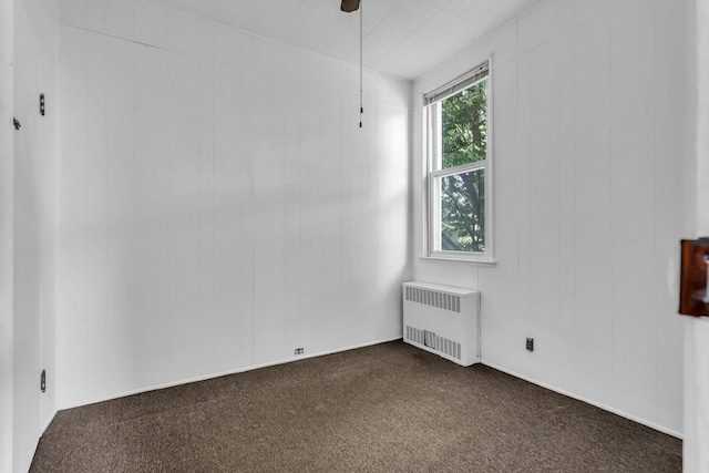 13-19 126th St, College Point, NY 11356 - empty room with radiator and dark carpet