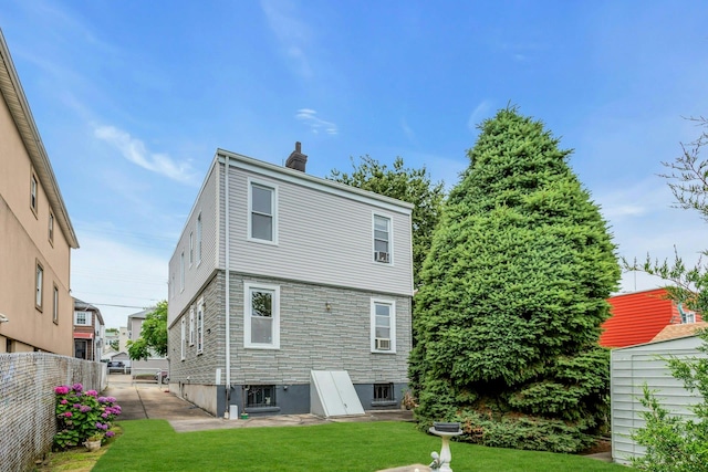 13-19 126th St, College Point, NY 11356 - rear view of house featuring a chimney