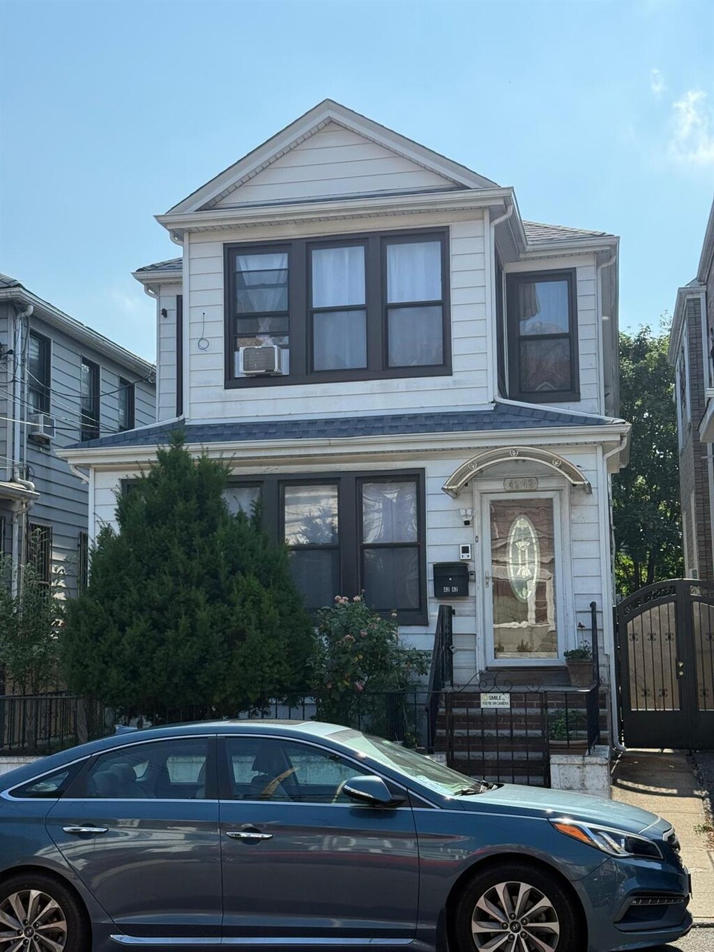 4242 79th St, Elmhurst, NY 11373 - view of front facade with a fenced front yard and a gate