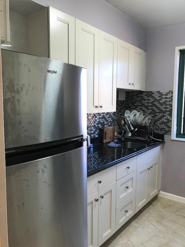 1935 Mcgraw Ave Unit 7C, Bronx, NY 10462 - kitchen with freestanding refrigerator, white cabinets, backsplash, and dark stone counters