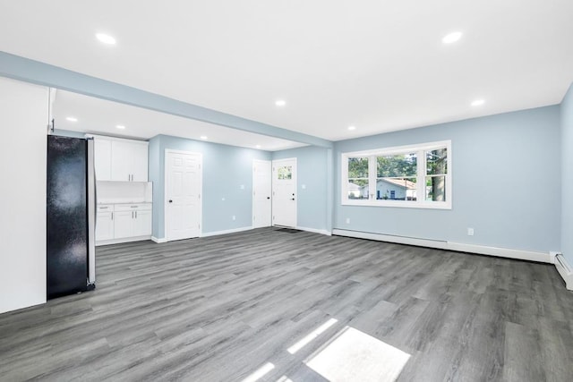 111A Wood Ave, Mastic, NY 11950 - unfurnished living room featuring light wood-type flooring, a baseboard heating unit, and recessed lighting