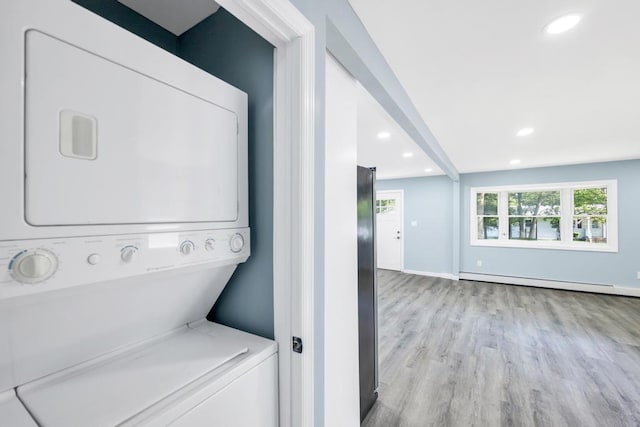 111A Wood Ave, Mastic, NY 11950 - laundry area featuring stacked washing machine and dryer, a baseboard heating unit, recessed lighting, and light wood-type flooring