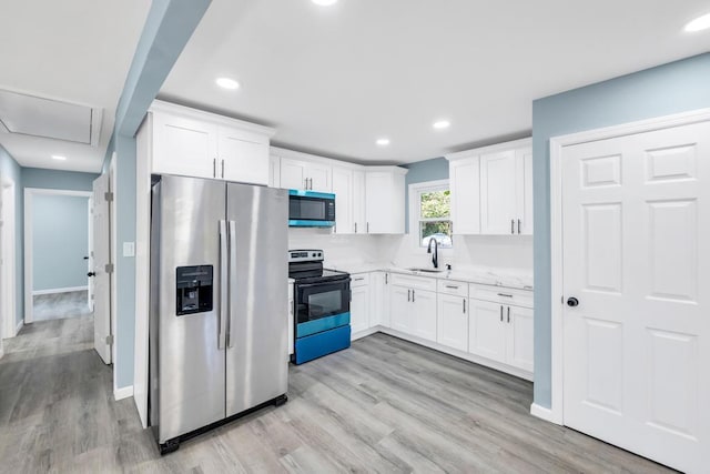 111A Wood Ave, Mastic, NY 11950 - kitchen with stainless steel refrigerator with ice dispenser, black electric range, white cabinetry, light wood-style flooring, and recessed lighting