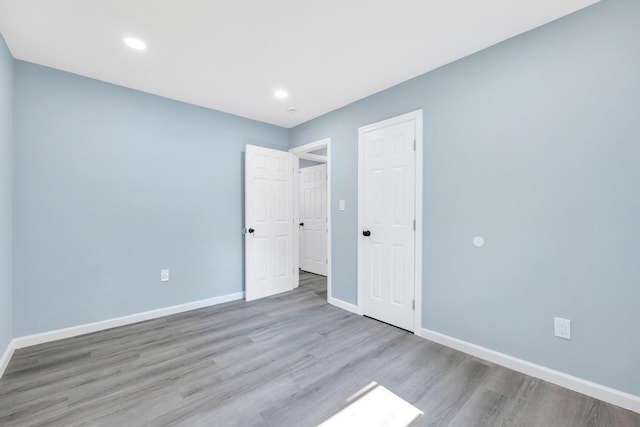 111A Wood Ave, Mastic, NY 11950 - unfurnished bedroom with wood finished floors and recessed lighting