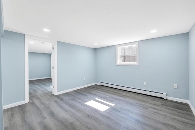 111A Wood Ave, Mastic, NY 11950 - below grade area with baseboard heating, wood finished floors, and recessed lighting