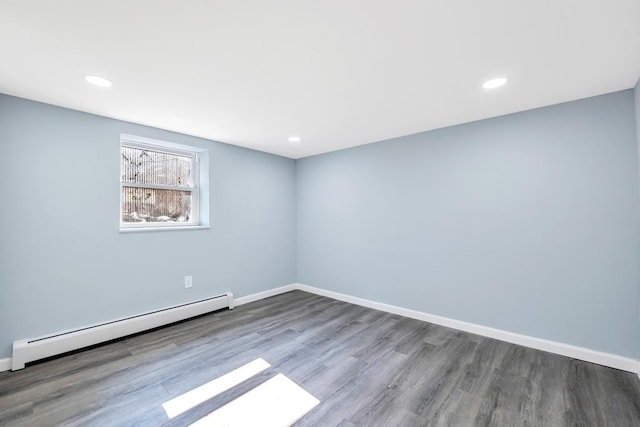 111A Wood Ave, Mastic, NY 11950 - empty room featuring a baseboard heating unit, wood finished floors, and recessed lighting