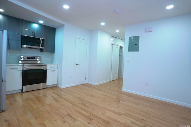 87-44 89th St, Woodhaven, NY 11421 - kitchen with stainless steel appliances, electric panel, light wood finished floors, light countertops, and recessed lighting
