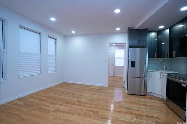 87-44 89th St, Woodhaven, NY 11421 - kitchen with refrigerator with ice dispenser, electric stove, light countertops, tasteful backsplash, and light wood-type flooring