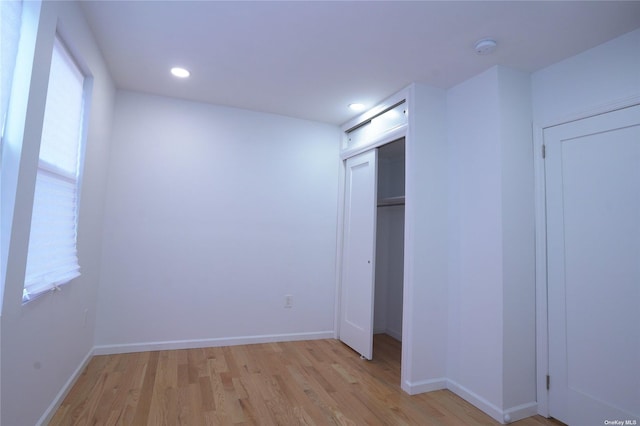 87-44 89th St, Woodhaven, NY 11421 - unfurnished bedroom with light wood-style flooring, recessed lighting, and a closet