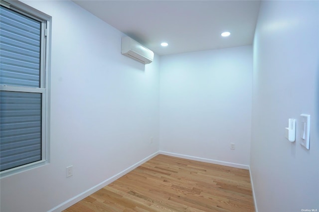 87-44 89th St, Woodhaven, NY 11421 - spare room featuring an AC wall unit, light wood-type flooring, and recessed lighting