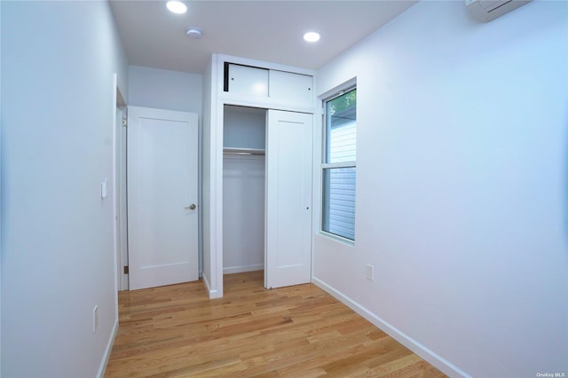 87-44 89th St, Woodhaven, NY 11421 - unfurnished bedroom featuring light wood-type flooring, a closet, recessed lighting, and an AC wall unit
