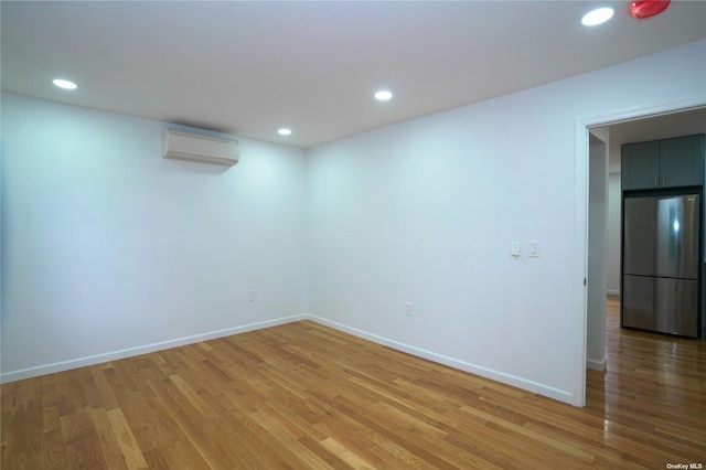 87-44 89th St, Woodhaven, NY 11421 - spare room featuring a wall mounted air conditioner, light wood-style floors, and recessed lighting