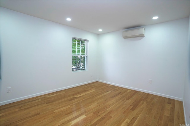 87-44 89th St, Woodhaven, NY 11421 - spare room with a wall mounted air conditioner, light wood-style flooring, and recessed lighting