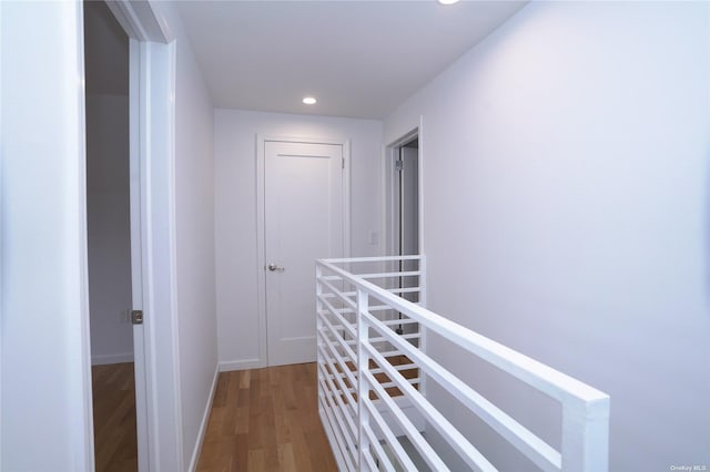 87-44 89th St, Woodhaven, NY 11421 - corridor with wood finished floors, recessed lighting, and an upstairs landing