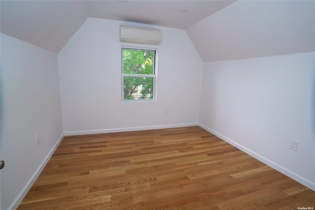 87-44 89th St, Woodhaven, NY 11421 - additional living space with a wall unit AC, vaulted ceiling, and light wood finished floors