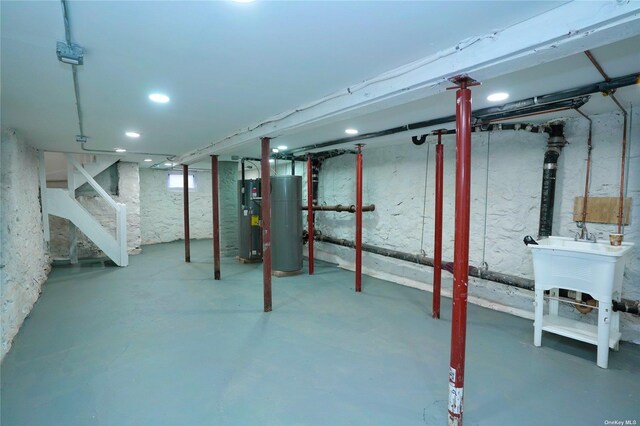 87-44 89th St, Woodhaven, NY 11421 - unfinished below grade area featuring stairs, water heater, gas water heater, and recessed lighting